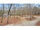 Home exterior with a long driveway surrounded by a forest at 679 Bo Bo Banks Rd, Grantville, GA 30220