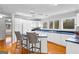 Kitchen featuring white cabinets and stainless steel appliances with wooden floors and bright lighting at 679 Bo Bo Banks Rd, Grantville, GA 30220