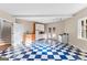 Beautiful kitchen features blue checkered flooring, cabinets, stove, and walk out doors at 679 Bo Bo Banks Rd, Grantville, GA 30220