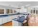 Bright kitchen featuring an island with chairs, white cabinets and stainless steel appliances at 679 Bo Bo Banks Rd, Grantville, GA 30220