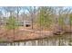 View of the lake and the back of the home from the side at 679 Bo Bo Banks Rd, Grantville, GA 30220