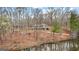 View of the lake and the back of the home with an elevated back porch at 679 Bo Bo Banks Rd, Grantville, GA 30220