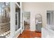 Living room featuring glass doors to a balcony and wood floors with a decorative mirror at 679 Bo Bo Banks Rd, Grantville, GA 30220