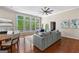 Open living room with hardwood floors, large windows, and comfortable seating at 679 Bo Bo Banks Rd, Grantville, GA 30220