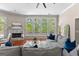 Bright living room featuring hardwood floors, a fireplace, and large windows with scenic views at 679 Bo Bo Banks Rd, Grantville, GA 30220