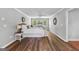 A spacious main bedroom with hardwood floors, neutral walls, and stylish decor at 679 Bo Bo Banks Rd, Grantville, GA 30220