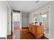 Office area with wooden floors, cabinet, lots of light, and easy access to sunroom and another living space at 679 Bo Bo Banks Rd, Grantville, GA 30220