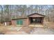 Exterior view of a spacious outbuilding, and separate storage with a large covered area at 679 Bo Bo Banks Rd, Grantville, GA 30220