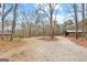 Gravel driveway leads to barn on this treed lot at 679 Bo Bo Banks Rd, Grantville, GA 30220