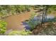 Aerial view of a serene pond, surrounded by lush greenery, and a dock at 679 Bo Bo Banks Rd, Grantville, GA 30220