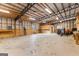 Interior of workshop showing spacious layout, wooden beams, high ceilings, and several workbenches at 679 Bo Bo Banks Rd, Grantville, GA 30220