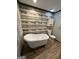 Bathroom with white claw foot tub and wood look ceramic tile at 223 Rivers Rd, Fayetteville, GA 30214
