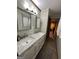 Bathroom with double marble sink, mirrors and view into room at 223 Rivers Rd, Fayetteville, GA 30214