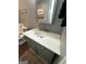 Bathroom with marble countertop, grey accent walls, decorative mirror, and toilet at 223 Rivers Rd, Fayetteville, GA 30214
