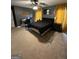 Bedroom featuring dark gray walls, ceiling fan, natural light, and workstation at 223 Rivers Rd, Fayetteville, GA 30214
