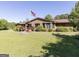 Brick home with an American flag in the front yard and well-manicured landscaping at 223 Rivers Rd, Fayetteville, GA 30214