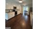 Kitchen with white cabinets, stainless appliances, with a dining room at 223 Rivers Rd, Fayetteville, GA 30214