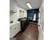 Well-lit laundry room featuring modern washer and dryer, sink, and custom storage at 223 Rivers Rd, Fayetteville, GA 30214