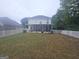 Large backyard featuring a white fence, screened-in porch, and lush green grass at 320 Weatherly Drive, Fayetteville, GA 30214