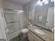 Bathroom features a shower and tub with glass doors, granite countertop vanity, and gray walls at 320 Weatherly Drive, Fayetteville, GA 30214