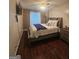Comfortable bedroom with a cozy bed, hardwood floors, and natural light from the window at 320 Weatherly Drive, Fayetteville, GA 30214
