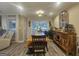 Bright dining area with modern lighting, a large rustic table, and an accent mirror at 320 Weatherly Drive, Fayetteville, GA 30214