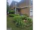 Charming home with lush landscaping, a 'Welcome' sign, and an ADT security system sign at 320 Weatherly Drive, Fayetteville, GA 30214