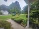 Lush front yard with manicured landscaping, neighborhood street, and a glimpse of a neighbor's home at 320 Weatherly Drive, Fayetteville, GA 30214