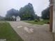 Neighborhood street view of a home across a well-manicured lawn with parked cars at 320 Weatherly Drive, Fayetteville, GA 30214