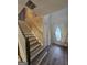 Well-lit hallway featuring staircase and elegant front door with decorative window at 320 Weatherly Drive, Fayetteville, GA 30214