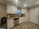 Bright kitchen boasts granite countertops, stainless steel appliances, and ample cabinet space at 320 Weatherly Drive, Fayetteville, GA 30214
