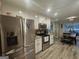 Modern kitchen featuring stainless steel appliances, granite countertops, and adjacent dining area at 320 Weatherly Drive, Fayetteville, GA 30214