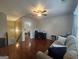 Inviting living room with hardwood floors, fan, and natural light, perfect for relaxation and entertaining at 320 Weatherly Drive, Fayetteville, GA 30214