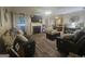 Inviting living room with stone fireplace, comfortable seating, and an open view to the dining area at 320 Weatherly Drive, Fayetteville, GA 30214