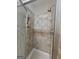 Shower with tiled walls, built in shelf, and glass door at 320 Weatherly Drive, Fayetteville, GA 30214