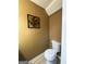 Compact half-bathroom featuring a standard toilet and simple wall decor at 5894 Par Three Ct, Lithonia, GA 30038