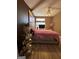 Bedroom featuring wood floors, a fluffy pink blanket, stylish art, and ample natural light at 5894 Par Three Ct, Lithonia, GA 30038