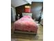 Bedroom featuring wood floors, fluffy pink blanket, stylish art, and natural light at 5894 Par Three Ct, Lithonia, GA 30038
