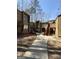 Inviting townhouse complex features a well-maintained walkway and natural surroundings on a sunny day at 5894 Par Three Ct, Lithonia, GA 30038