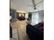 An open-concept living room with wood flooring, an accent wall and a cozy seating area at 5894 Par Three Ct, Lithonia, GA 30038