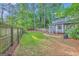 The large, grassy yard is surrounded by a wooden fence, providing privacy and security at 4250 Edgewater Nw Ct, Kennesaw, GA 30144