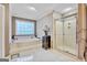 Spa-like bathroom featuring a soaking tub, glass-enclosed shower, and serene ambiance at 4250 Edgewater Nw Ct, Kennesaw, GA 30144