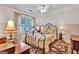 Charming bedroom with an iron bed frame, floral rug, and natural light at 4250 Edgewater Nw Ct, Kennesaw, GA 30144