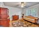 Comfortable bedroom featuring a sofa, wood floors, and natural light at 4250 Edgewater Nw Ct, Kennesaw, GA 30144