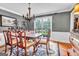 Dining room with hardwood floors, a large window overlooking the backyard, and a formal dining set, ideal for Gathering gatherings at 4250 Edgewater Nw Ct, Kennesaw, GA 30144