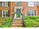 Elegant brick entryway with black door, sidelights, and manicured landscaping at 4250 Edgewater Nw Ct, Kennesaw, GA 30144