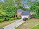 Charming two-story brick home with a spacious driveway and mature trees at 4250 Edgewater Nw Ct, Kennesaw, GA 30144