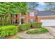 Charming two-story brick home with a well-manicured lawn and lush landscaping at 4250 Edgewater Nw Ct, Kennesaw, GA 30144