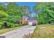 Brick home with a long driveway and mature landscaping providing shade and curb appeal at 4250 Edgewater Nw Ct, Kennesaw, GA 30144