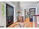 Welcoming foyer with hardwood floors, black door, and decorative furnishings at 4250 Edgewater Nw Ct, Kennesaw, GA 30144